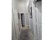 Neutral hallway featuring tile floors with carpet and multiple doorways at 824 Holly Lake Way, Henderson, NV 89002