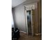 Open bi-fold hallway closet door in a gray-painted room, revealing additional storage space and a glimpse into the home's layout at 824 Holly Lake Way, Henderson, NV 89002