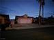 One story home with tile roof and desert landscaping at dusk at 824 Holly Lake Way, Henderson, NV 89002
