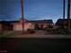 One story home with tile roof and desert landscaping at dusk at 824 Holly Lake Way, Henderson, NV 89002