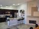 Bright kitchen with an island, stainless steel appliances, dark cabinets, and a cozy fireplace at 824 Holly Lake Way, Henderson, NV 89002