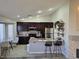 Open-concept kitchen with stainless steel appliances, island seating, and ample natural light at 824 Holly Lake Way, Henderson, NV 89002