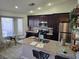 Well-lit kitchen with an island, granite countertops, and stainless steel appliances at 824 Holly Lake Way, Henderson, NV 89002