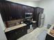 Updated kitchen with granite counters, stainless steel appliances, and dark brown cabinets at 824 Holly Lake Way, Henderson, NV 89002