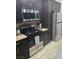 Modern kitchen features stainless steel appliances, granite countertops, and dark brown cabinetry at 824 Holly Lake Way, Henderson, NV 89002