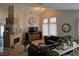 Comfortable living room featuring a decorative fireplace, tile flooring, and natural lighting at 824 Holly Lake Way, Henderson, NV 89002