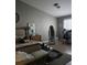 Sunlit bedroom with hardwood floors, ceiling fan, a desk area, and a comfortable bed at 824 Holly Lake Way, Henderson, NV 89002