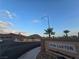 Street view of Palm Canyon entry sign in residential community near mountains on a clear, sunny day at 824 Holly Lake Way, Henderson, NV 89002