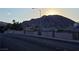 Street view showcasing mountain views behind the community fence and homes at 824 Holly Lake Way, Henderson, NV 89002