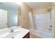 This is a clean, bright bathroom with a tub and shower, tile floors, and a large mirror at 8329 Brilliant Ruby Ct, Las Vegas, NV 89139