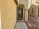 Inviting front entrance with an arched doorway and stylish gray door at 8329 Brilliant Ruby Ct, Las Vegas, NV 89139