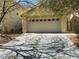 Attached two-car garage with a neutral color palette and well-maintained driveway at 8329 Brilliant Ruby Ct, Las Vegas, NV 89139