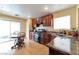 Bright kitchen with granite countertops, dark wood cabinets, and backyard access at 8329 Brilliant Ruby Ct, Las Vegas, NV 89139