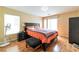 Comfortable main bedroom featuring wood floors, natural light, and a sliding door to the outside at 8329 Brilliant Ruby Ct, Las Vegas, NV 89139