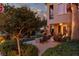 Serene backyard showing manicured landscaping, a fire pit with seating, and a glimpse of the home at 9000 Thornbury Ln, Las Vegas, NV 89134