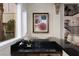 Wet bar area with dark countertops, wine bottle rack, and stairs in view at 9000 Thornbury Ln, Las Vegas, NV 89134