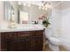 Elegant bathroom with dark wood vanity, white countertops, and classic fixtures, providing a timeless aesthetic at 9000 Thornbury Ln, Las Vegas, NV 89134