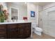 Well-lit bathroom features a double vanity, tile flooring, and a glass enclosed shower at 9000 Thornbury Ln, Las Vegas, NV 89134