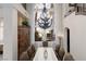 Dining area featuring a large window, stylish chandelier, and views of the well-manicured backyard at 9000 Thornbury Ln, Las Vegas, NV 89134