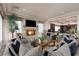 Spacious living room with a fireplace, large windows, and an open view into the kitchen at 9000 Thornbury Ln, Las Vegas, NV 89134