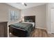 Bright bedroom featuring wood-look flooring, large window and closet, creating a clean and modern living space at 9050 W Warm Springs Rd # 1093, Las Vegas, NV 89148