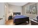 Well-lit bedroom with wood-look floors, complemented by a large window for natural light and a neutral color palette at 9050 W Warm Springs Rd # 1093, Las Vegas, NV 89148