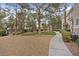 Landscaped community grounds with mature trees, decorative rock, manicured bushes, and convenient walking paths at 9050 W Warm Springs Rd # 1093, Las Vegas, NV 89148