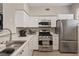 Well-lit kitchen featuring stainless steel appliances and sleek white cabinetry at 9050 W Warm Springs Rd # 1093, Las Vegas, NV 89148
