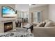 Cozy living room with fireplace, ceiling fan, and sliding door access to the outside at 9050 W Warm Springs Rd # 1093, Las Vegas, NV 89148