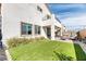 A spacious backyard shows a patio, artificial grass, and a neutral color scheme at 9380 Lunar Effect St, Las Vegas, NV 89143
