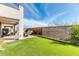 Beautiful backyard with lush artificial grass, a patio, and privacy fencing for outdoor enjoyment at 9380 Lunar Effect St, Las Vegas, NV 89143