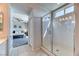 Bright bathroom featuring a glass shower, tiled floors, and doorway view into the bedroom at 9380 Lunar Effect St, Las Vegas, NV 89143