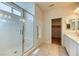 Bathroom featuring a glass shower with a built-in bench and a vanity area with quartz countertops at 9380 Lunar Effect St, Las Vegas, NV 89143