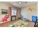 Playful room with custom dinosaur decor, plush carpeting, and a ball pit at 9380 Lunar Effect St, Las Vegas, NV 89143