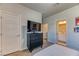 Bright bedroom features a TV, closet, and an ensuite bathroom at 9380 Lunar Effect St, Las Vegas, NV 89143