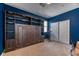 Cozy bedroom with a custom built-in storage unit with shelving and access to closet at 9380 Lunar Effect St, Las Vegas, NV 89143