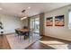 Stylish dining room with wood floors, access to patio, and modern decor at 9380 Lunar Effect St, Las Vegas, NV 89143