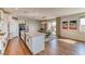 Open kitchen with island that flows into dining area with sliding doors at 9380 Lunar Effect St, Las Vegas, NV 89143