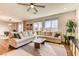 Inviting living room with large sectional sofa, wood floors and plenty of natural light at 9380 Lunar Effect St, Las Vegas, NV 89143