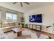 Cozy living room with sectional couch, natural light, and modern entertainment center at 9380 Lunar Effect St, Las Vegas, NV 89143