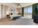 Spacious main bedroom with ceiling fan, balcony access, and stylish furnishings at 9380 Lunar Effect St, Las Vegas, NV 89143