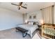 Main bedroom with ceiling fan, neutral decor, and a crib for a baby at 9380 Lunar Effect St, Las Vegas, NV 89143