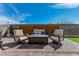 Cozy outdoor patio featuring comfortable seating, a fire pit, and a stylish brick paver design at 9380 Lunar Effect St, Las Vegas, NV 89143