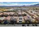 An aerial view of homes with solar panels, well-kept landscaping, and a nearby school at 9508 Wakashan Ave, Las Vegas, NV 89149