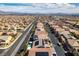 Expansive aerial of a Las Vegas neighborhood featuring solar panels, lush landscaping, and accessible roadways at 9508 Wakashan Ave, Las Vegas, NV 89149