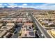 A neighborhood aerial view highlighting many homes with solar panels and distant mountain views at 9508 Wakashan Ave, Las Vegas, NV 89149