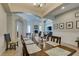 Spacious dining room featuring a wooden table set for dinner with views to the living room with a fireplace at 9508 Wakashan Ave, Las Vegas, NV 89149