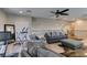 Open living area with ceiling fan, workout equipment, wood floors, and ample seating at 9508 Wakashan Ave, Las Vegas, NV 89149