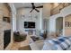 Bright living room featuring a cozy fireplace, high ceilings, and a large television at 9508 Wakashan Ave, Las Vegas, NV 89149