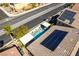 Aerial shot of a backyard pool with covered lounging area, palm trees, and solar panels on the roof at 9508 Wakashan Ave, Las Vegas, NV 89149